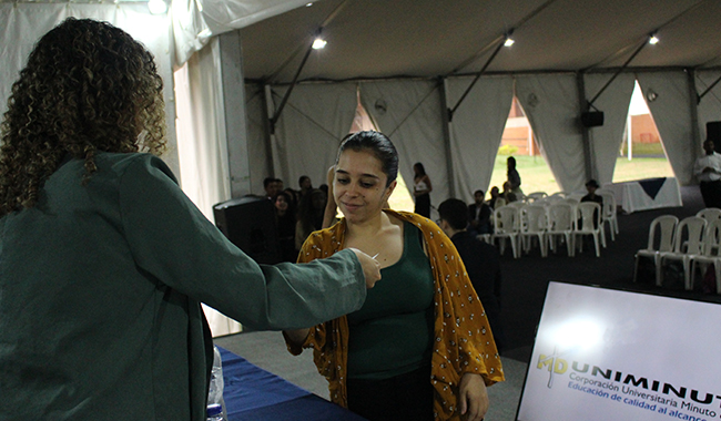 Estudiante recibiendo su certificado de beca en el escenario