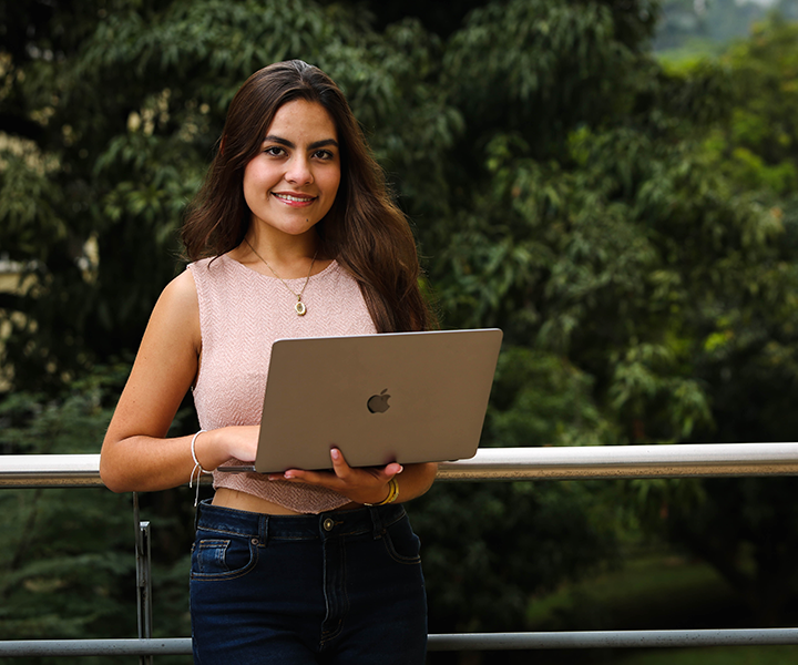 estudiante con computador en la mano