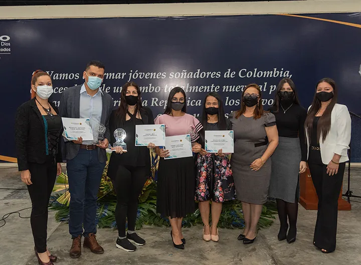 Los ganadores del concurso de experiencia ssignificativas, sostienen su estatuilla y diploma